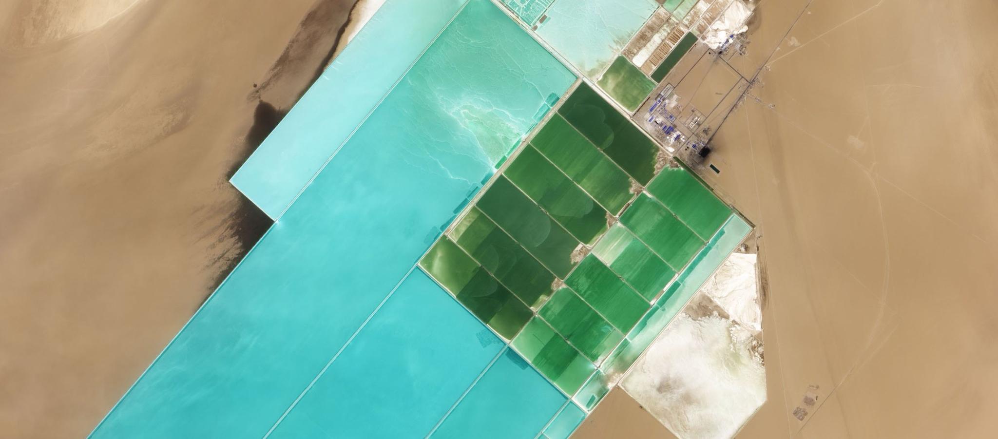 Turquoise and green potash evaporation ponds laid out across the desert at Lop Nur, China.